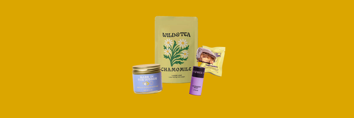 Belly butter jar, chamomile tea pouch, lip balm tube and a nougat candy bar on a mustard yellow background