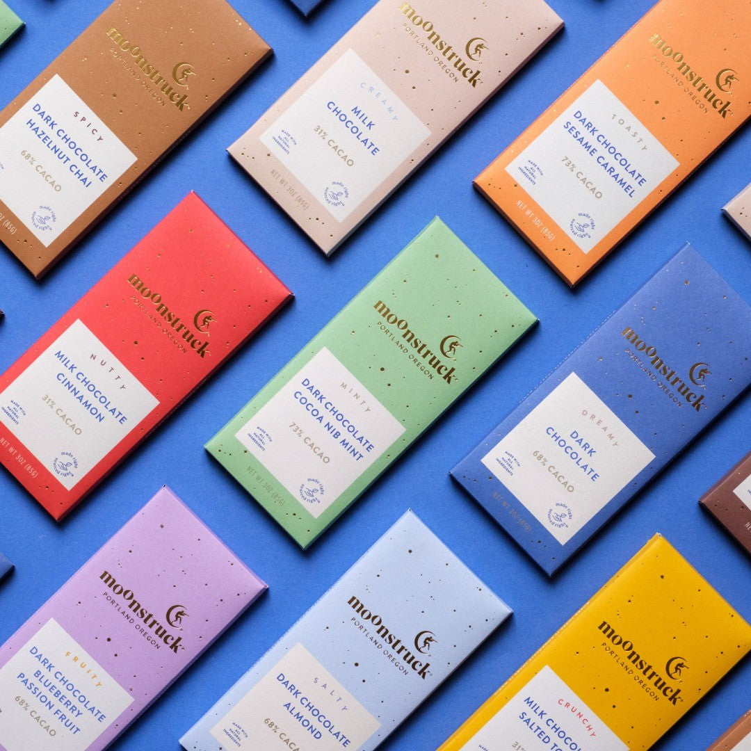 Moonstruck chocolate bars in various flavors on a blue background